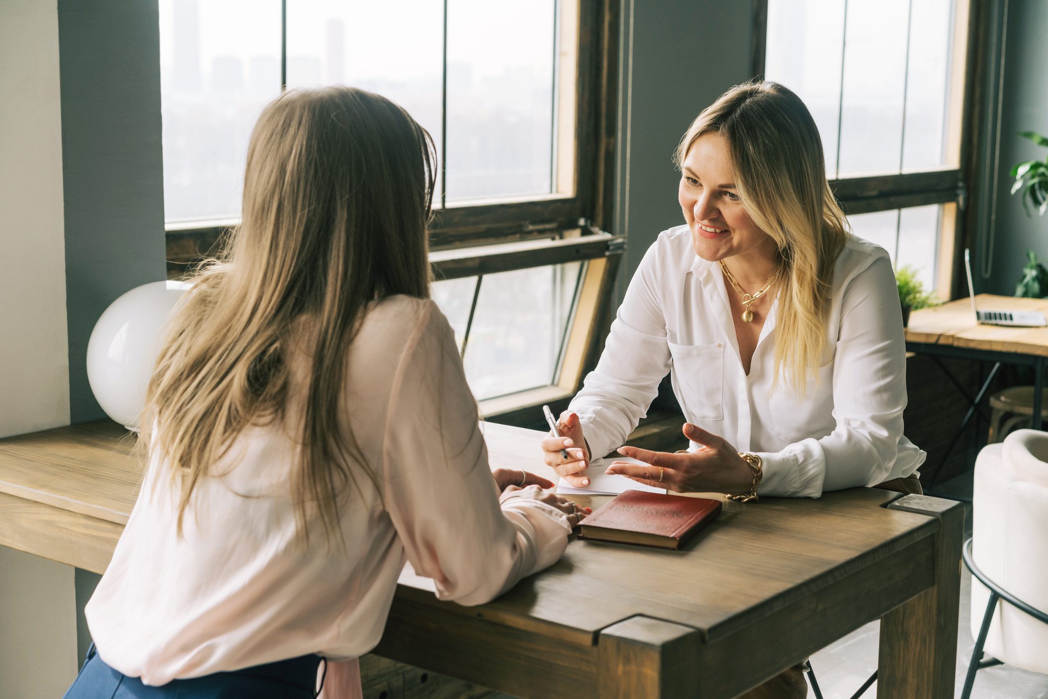 Woman psychologist talking to patient girl